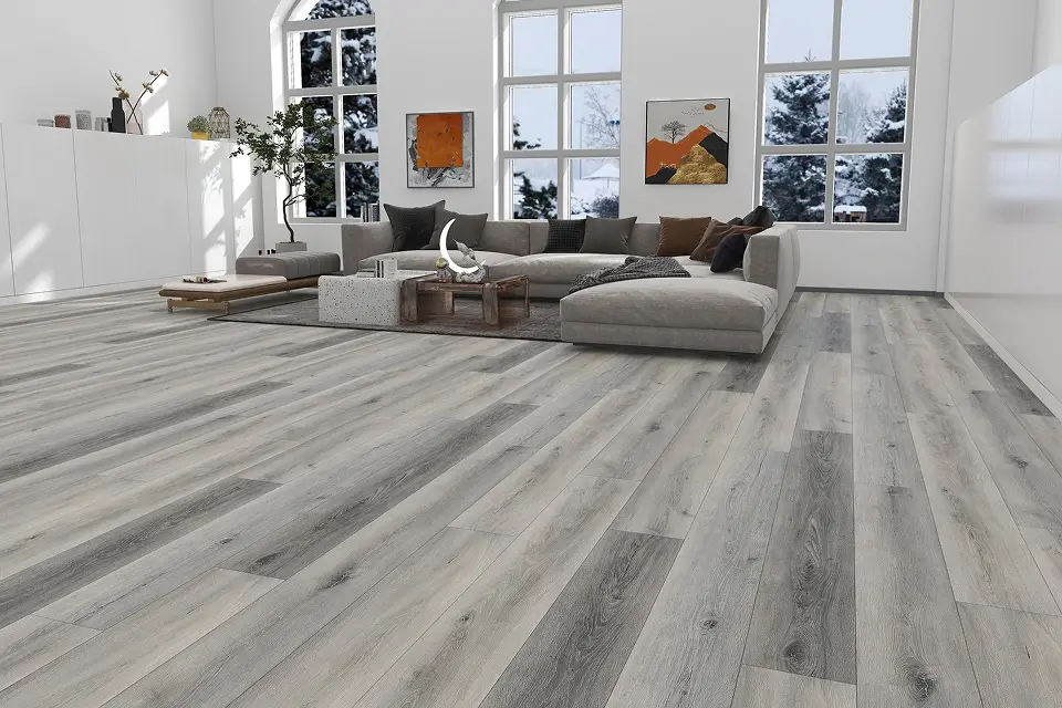 Spacious modern living room with grey wood-look laminate flooring and large windows.